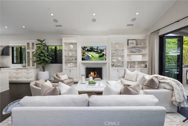a living room with furniture large window and fireplace