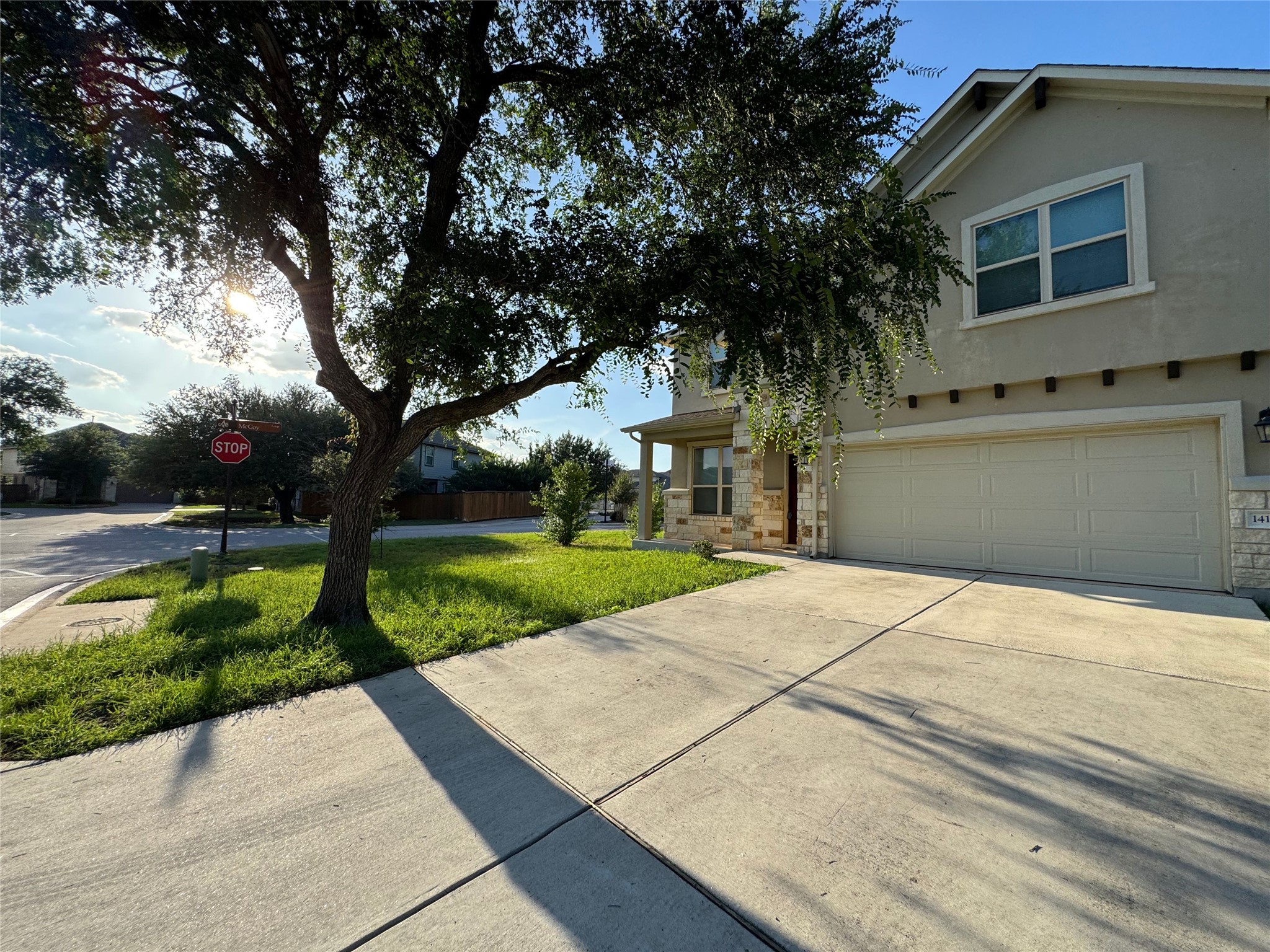 An inviting exterior with a two-car garage and stone accents welcomes you home.