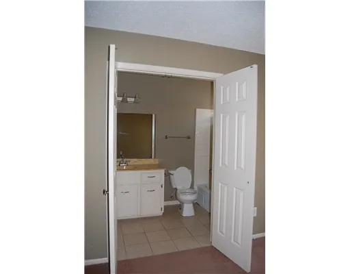 a bathroom with a toilet sink and a mirror