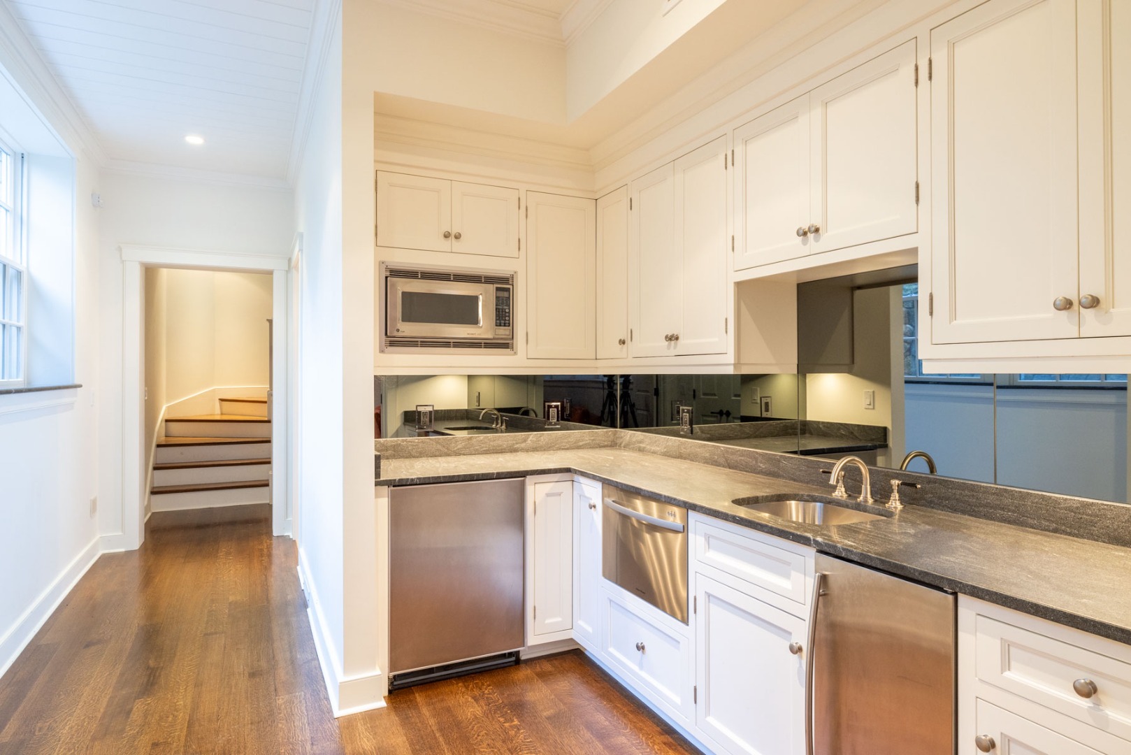 24 Katama Bay View Road Edgartown, MA 02539 - Photo 16 of 26 a kitchen with granite countertop white cabinets and stainless steel appliances