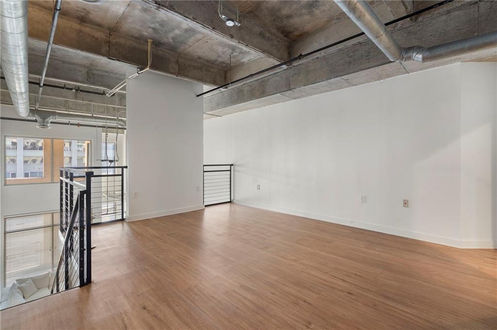 260 18th Street Northwest, Unit 10224 Atlanta, GA 30363 - Photo 13 of 47 a view of an empty room with wooden floor