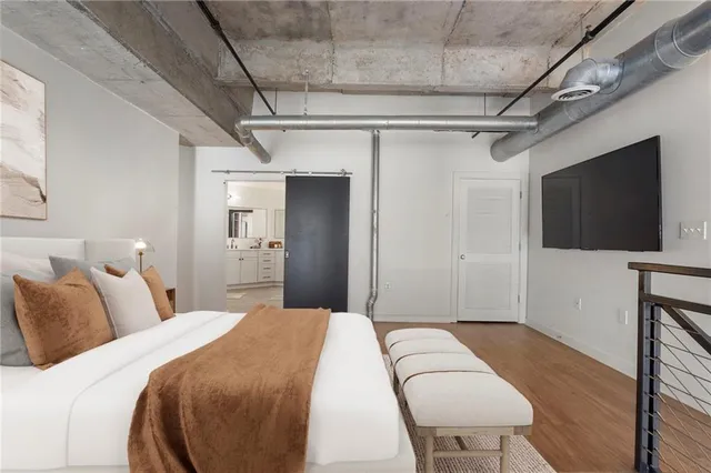 a bedroom with a bed and a flat screen tv