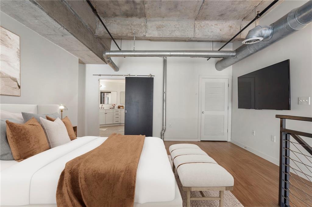 260 18th Street Northwest, Unit 10224 Atlanta, GA 30363 - Photo 14 of 47 a bedroom with a bed and a flat screen tv