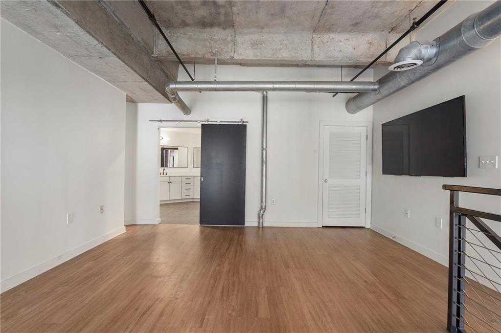 260 18th Street Northwest, Unit 10224 Atlanta, GA 30363 - Photo 15 of 47 a view of a livingroom with wooden floor