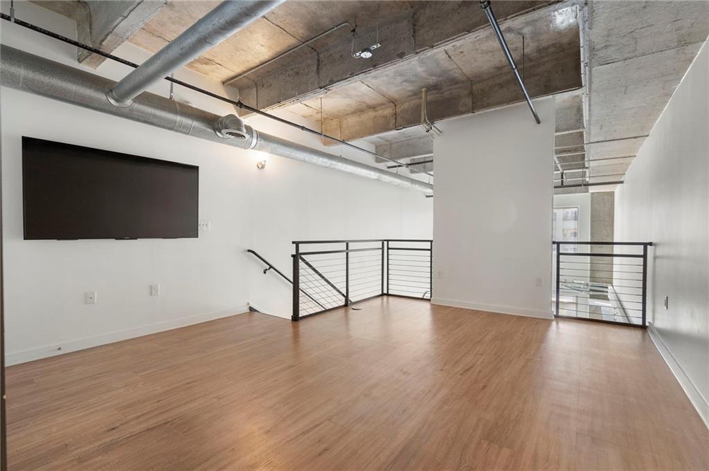 260 18th Street Northwest, Unit 10224 Atlanta, GA 30363 - Photo 16 of 47 a view of a livingroom with wooden floor