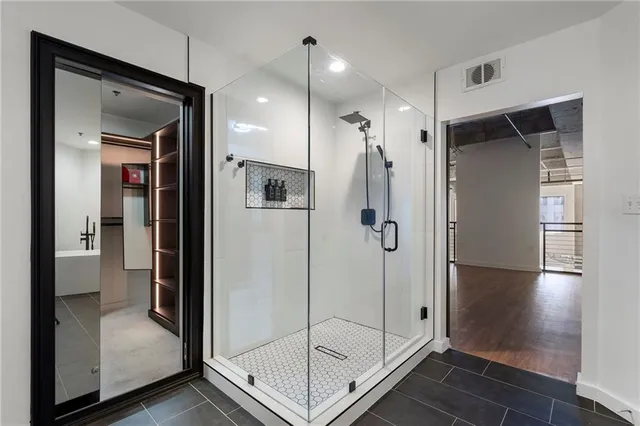 a bathroom with a shower and a glass door