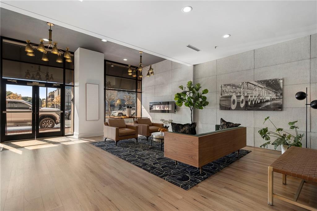 260 18th Street Northwest, Unit 10224 Atlanta, GA 30363 - Photo 30 of 47 a living room with furniture and wooden floor