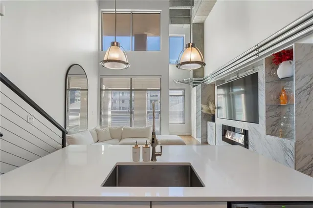 a living room with furniture and chandelier