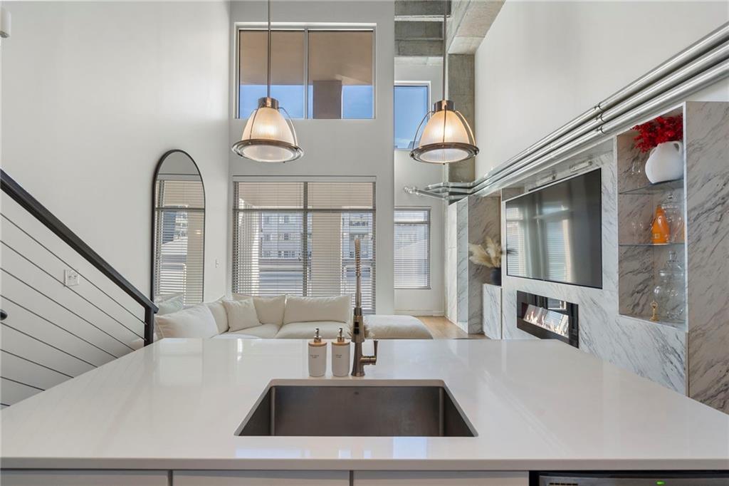 260 18th Street Northwest, Unit 10224 Atlanta, GA 30363 - Photo 7 of 47 a living room with furniture and chandelier