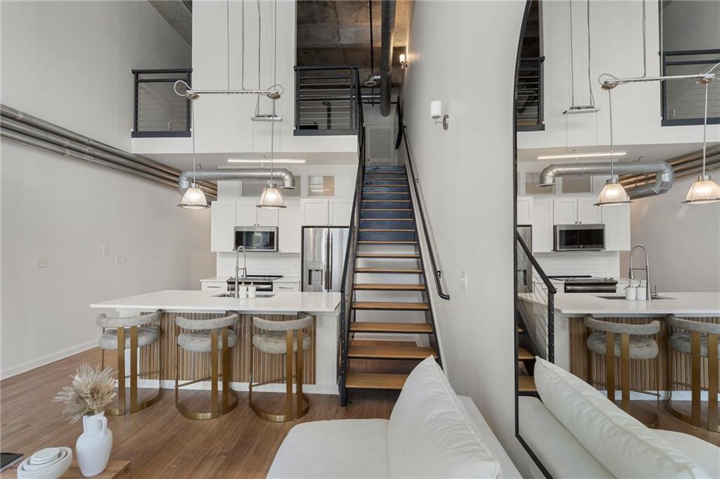 260 18th Street Northwest, Unit 10224 Atlanta, GA 30363 - Photo 8 of 47 a view of a kitchen with furniture and wooden floor