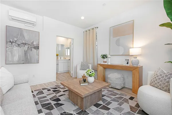 a living room with furniture and a potted plant