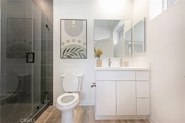 a bathroom with a toilet sink and shower