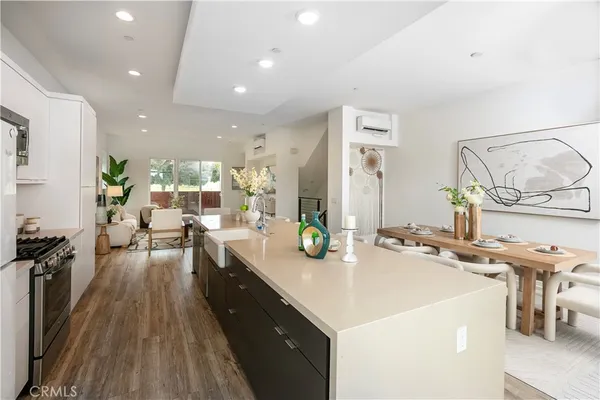 a large kitchen with a large counter top appliances and furniture