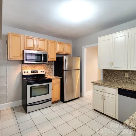 a kitchen with cabinets stainless steel appliances and counter space