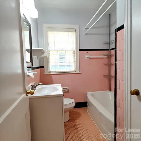 a bathroom with a sink toilet and tub