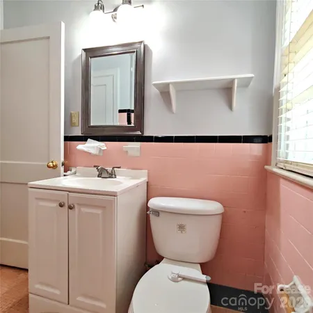 a bathroom with a toilet sink and mirror