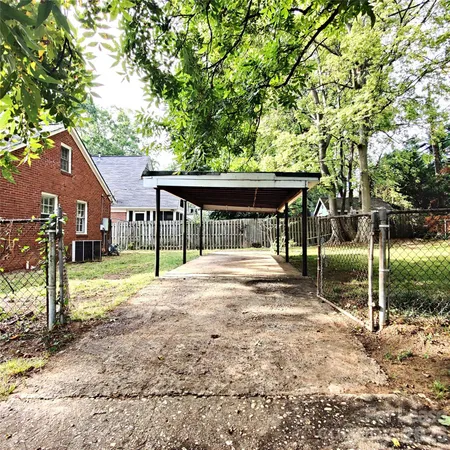 a view of house with backyard and seating area