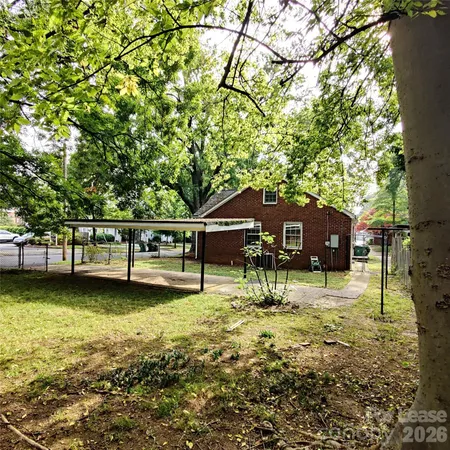 a view of a house with yard and sitting area