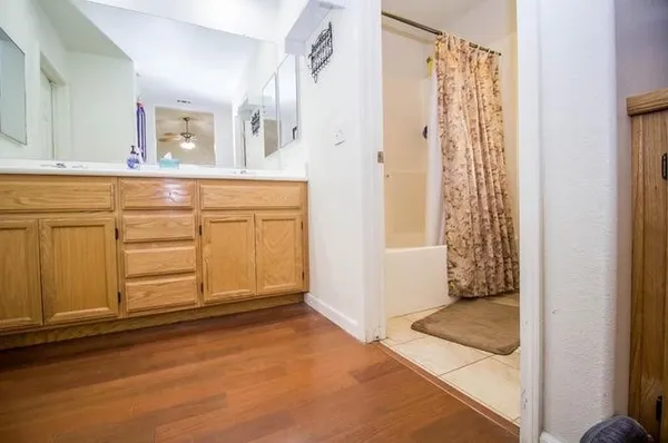 a view of a kitchen with white cabinets and a wooden floor
