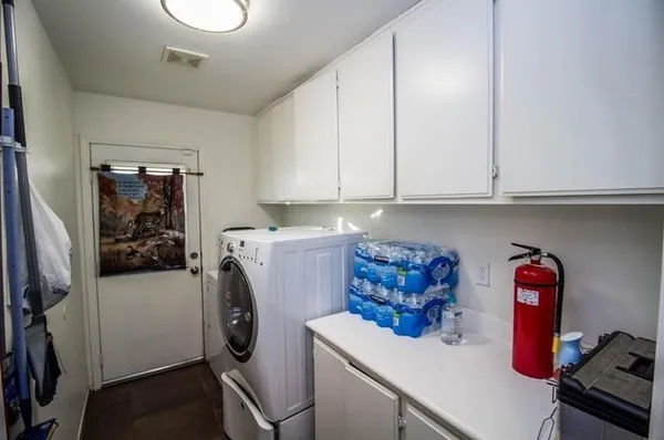 a utility room with sink dryer and washer