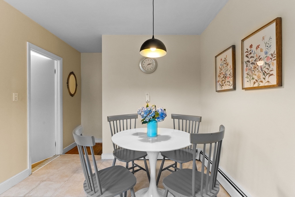 60 Goshen Road Dedham, MA 02026 - Photo 12 of 37 a view of a dining room with furniture and wooden floor