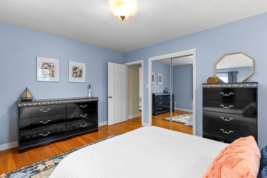60 Goshen Road Dedham, MA 02026 - Photo 14 of 37 a bedroom with a bed and wooden floor