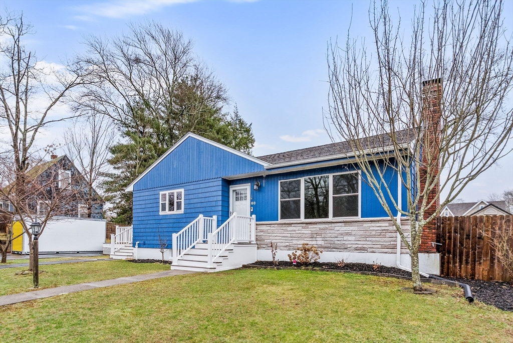 60 Goshen Road Dedham, MA 02026 - Photo 2 of 37 a front view of a house with a yard and garage