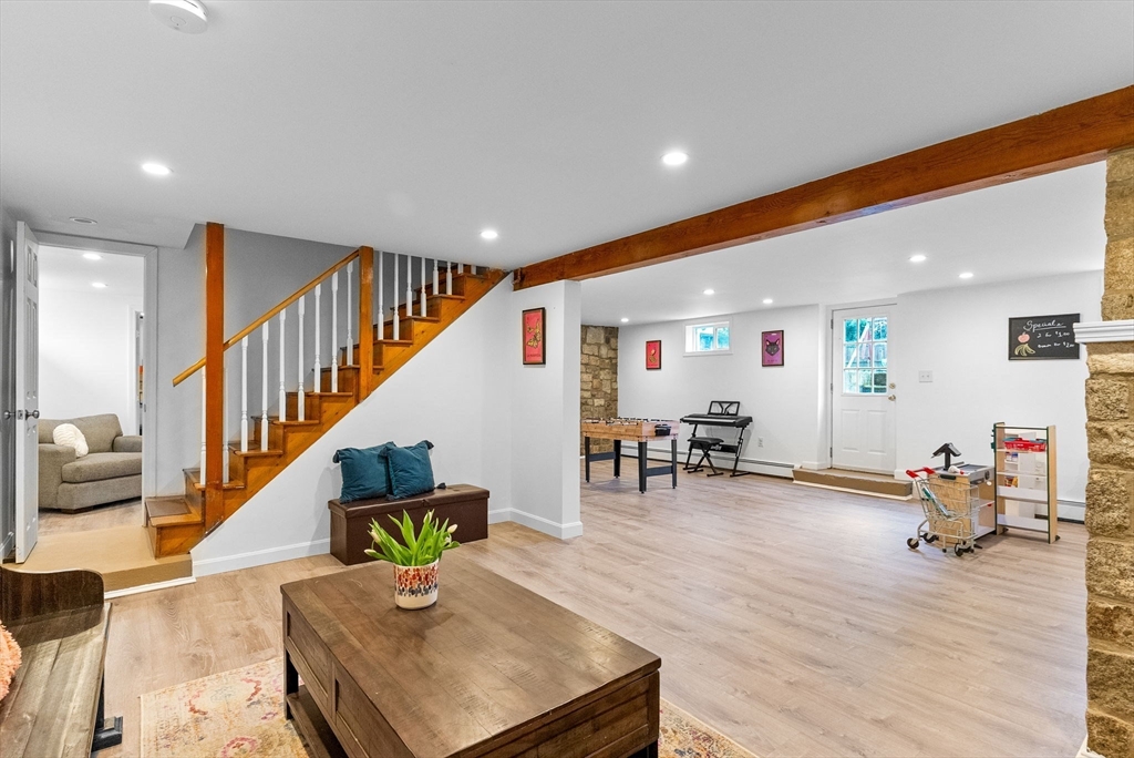 60 Goshen Road Dedham, MA 02026 - Photo 22 of 37 a living room with furniture and a dining table with wooden floor