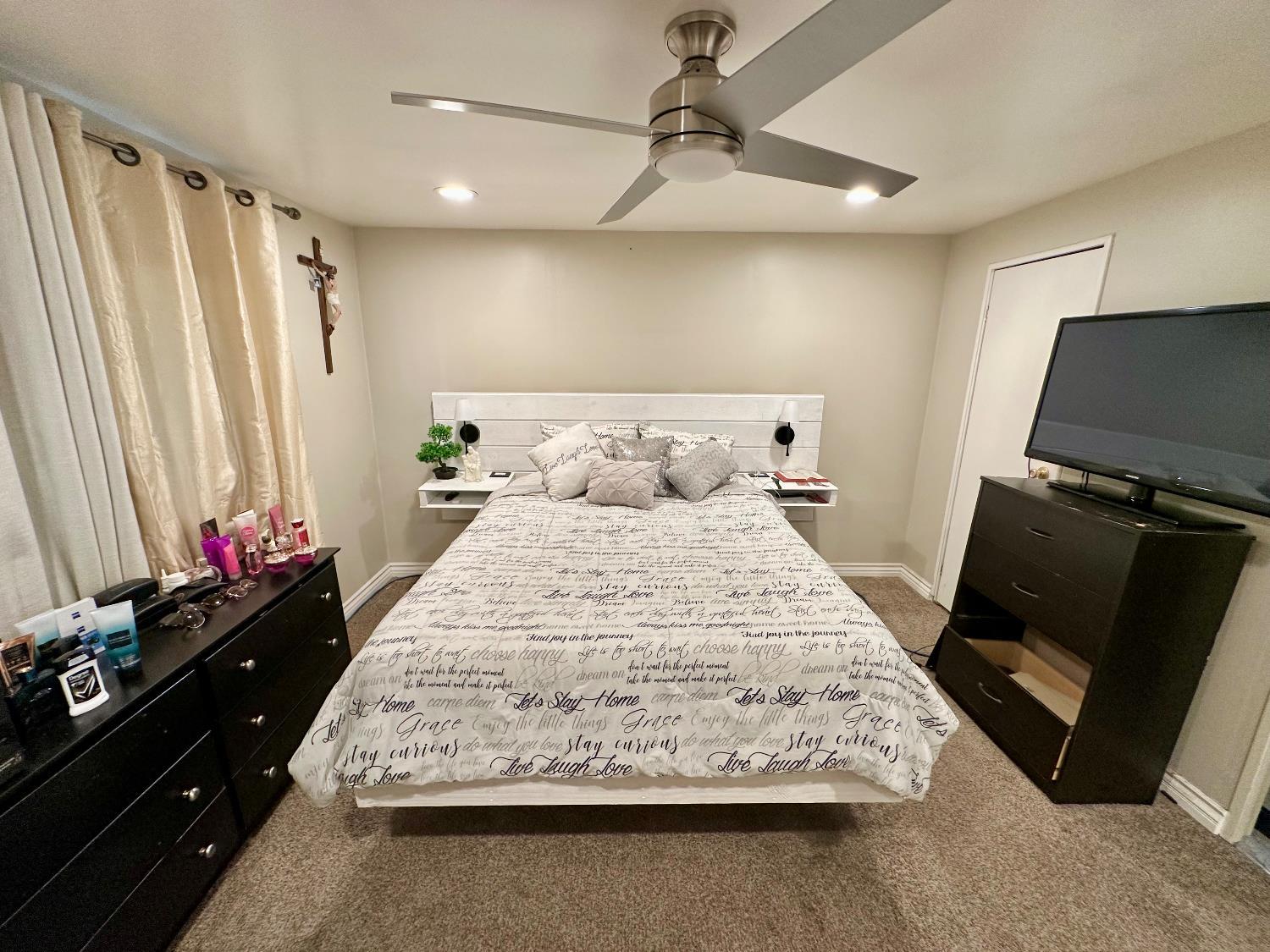 3435 Marfargoa Road, Unit 74 Stockton, CA 95215 - Photo 7 of 21 a bedroom with a bed and flat screen tv