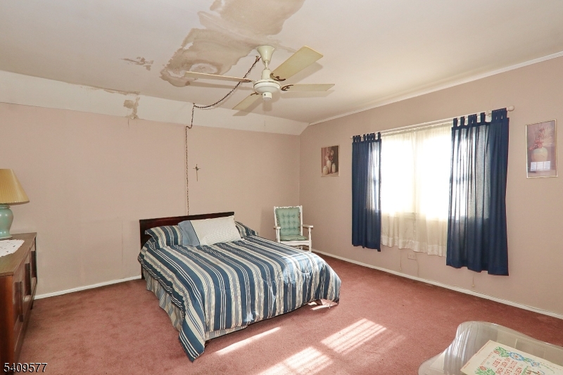 587 Thoreau Terrace Union, NJ 07083 - Photo 19 of 27 a bedroom with a bed and window