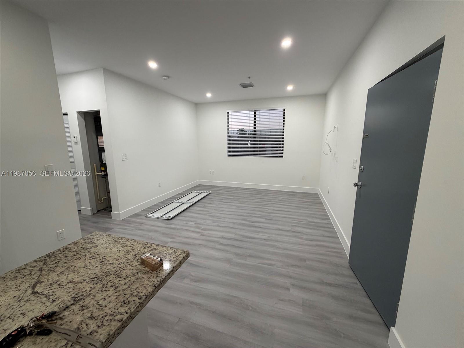 an entryway in a hall with wooden floor