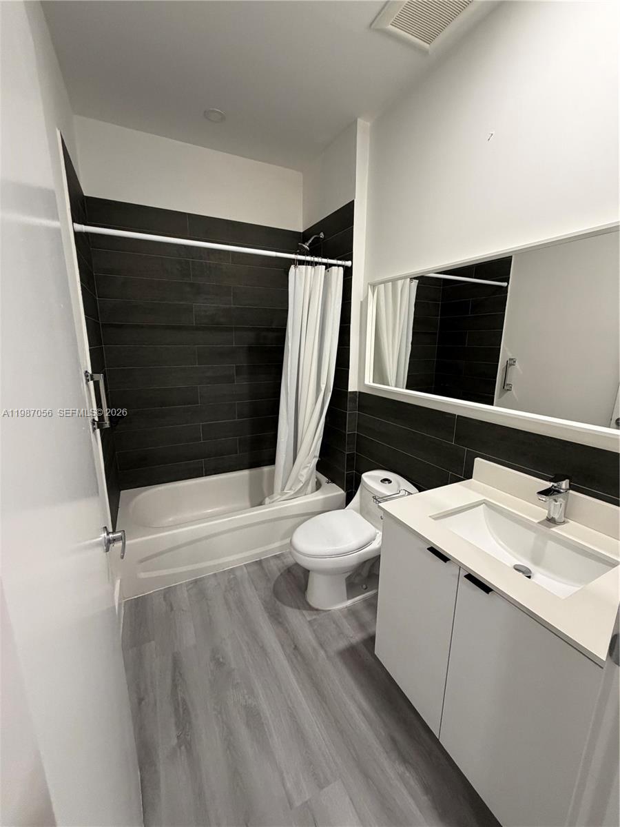 859 East 24th Street, Unit 404 Hialeah, FL 33013 - Photo 12 of 18 a bathroom with a sink a toilet a shower and a mirror