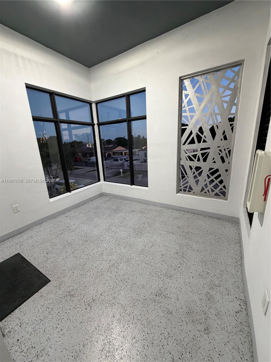 859 East 24th Street, Unit 404 Hialeah, FL 33013 - Photo 16 of 18 a view of an empty room with windows