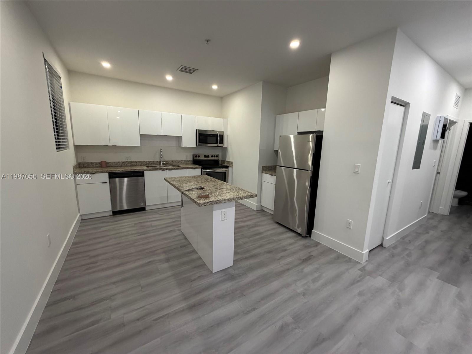 859 East 24th Street, Unit 404 Hialeah, FL 33013 - Photo 2 of 18 a kitchen with stainless steel appliances a refrigerator and a stove top oven