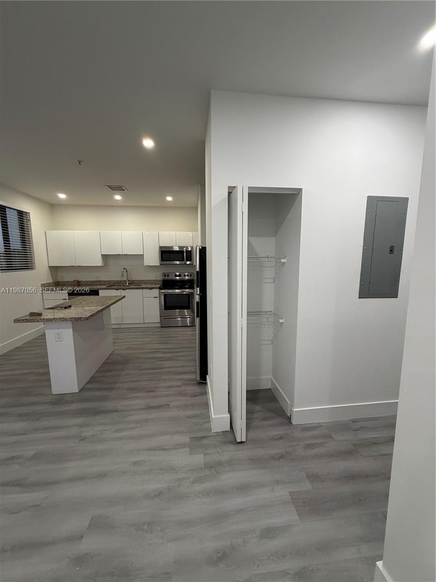 859 East 24th Street, Unit 404 Hialeah, FL 33013 - Photo 4 of 18 a view of kitchen with wooden floor