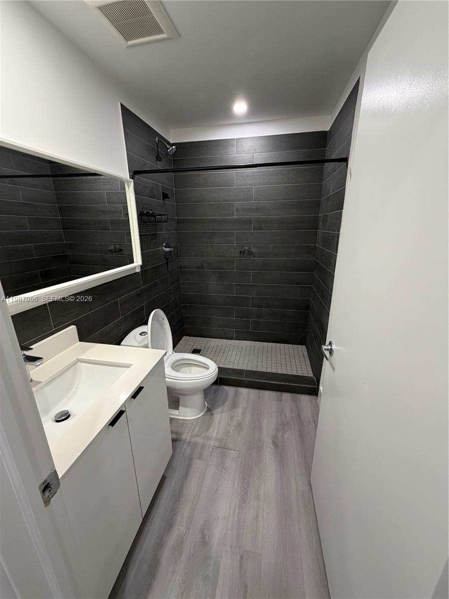 859 East 24th Street, Unit 404 Hialeah, FL 33013 - Photo 9 of 18 a bathroom with a sink a toilet and shower