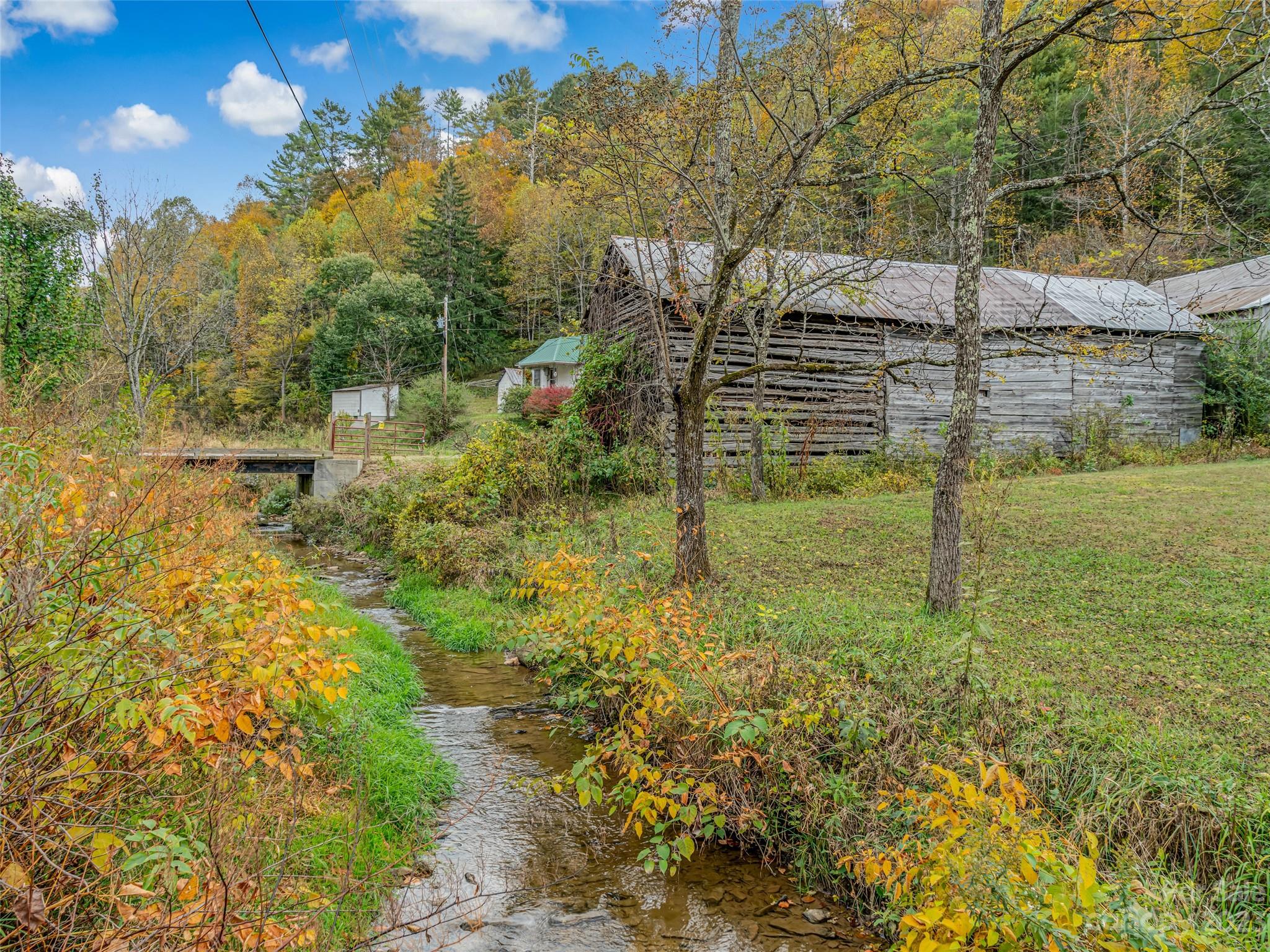 693 Sharp Hollow Road Marshall, NC 28753 - Photo 33 of 46 a view of a yard with a house in the background