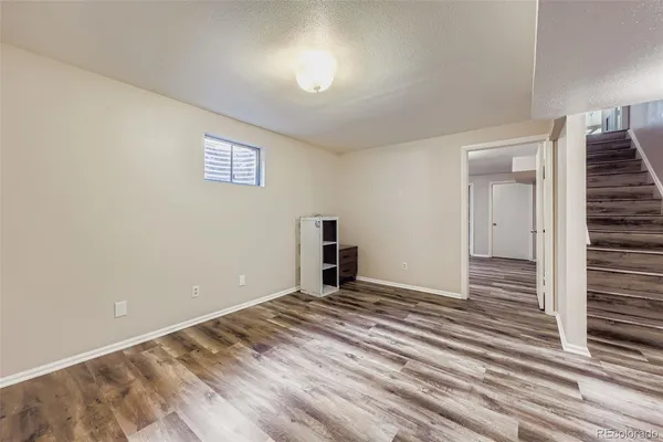 a view of a room with wooden floor