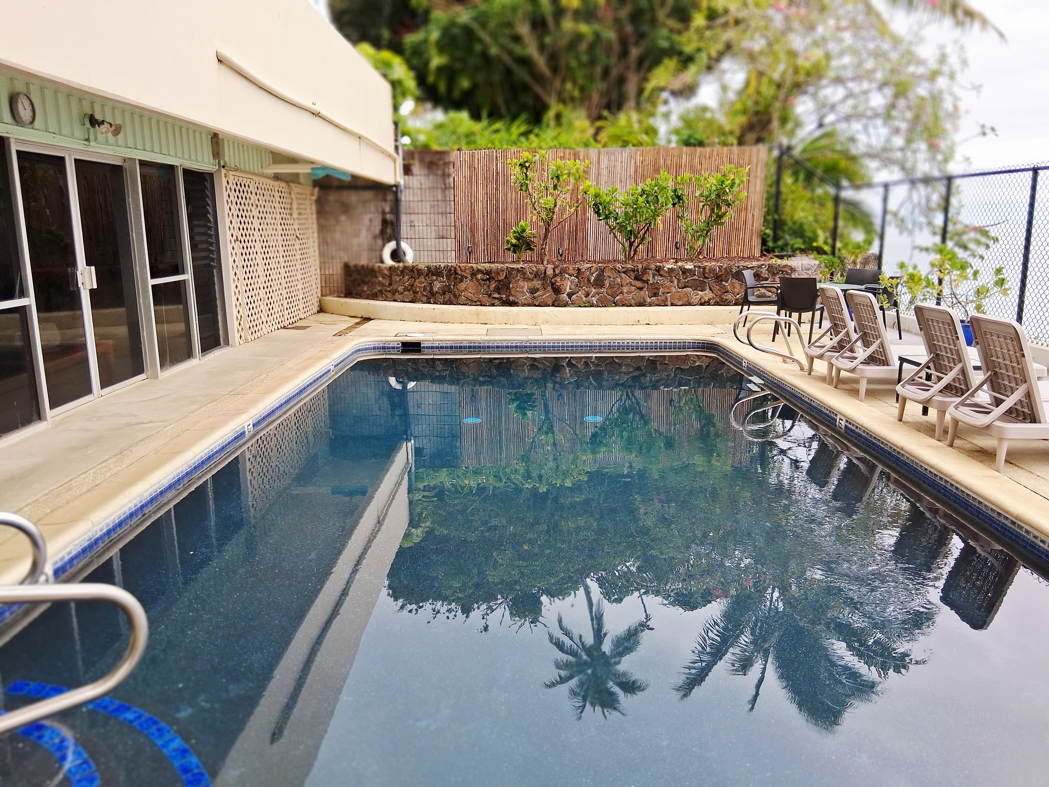 84 Pukihae Street, Unit 404 Hilo, HI 96720 - Photo 14 of 16 a view of a swimming pool with a patio