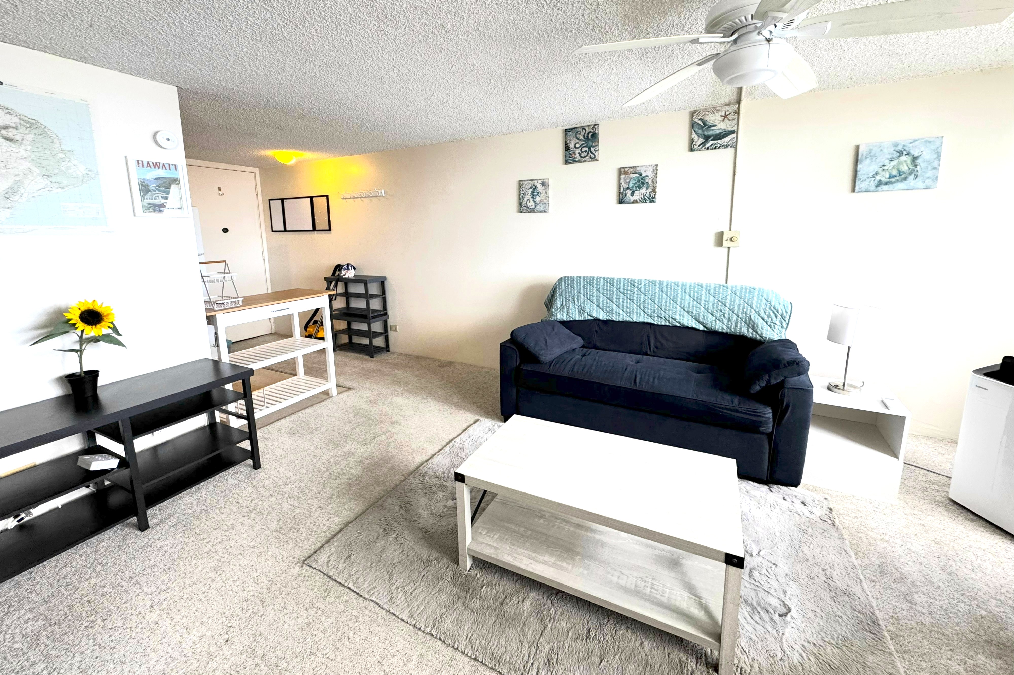 84 Pukihae Street, Unit 404 Hilo, HI 96720 - Photo 5 of 16 a living room with furniture and a flat screen tv