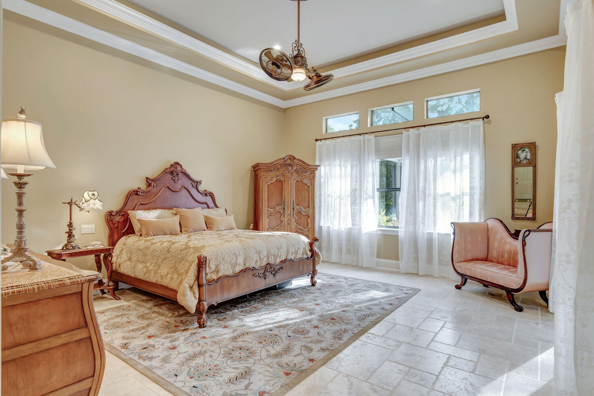 428 Captains Circle Destin, FL 32541 - Photo 23 of 88 a spacious bedroom with a bed a couch and a chandelier
