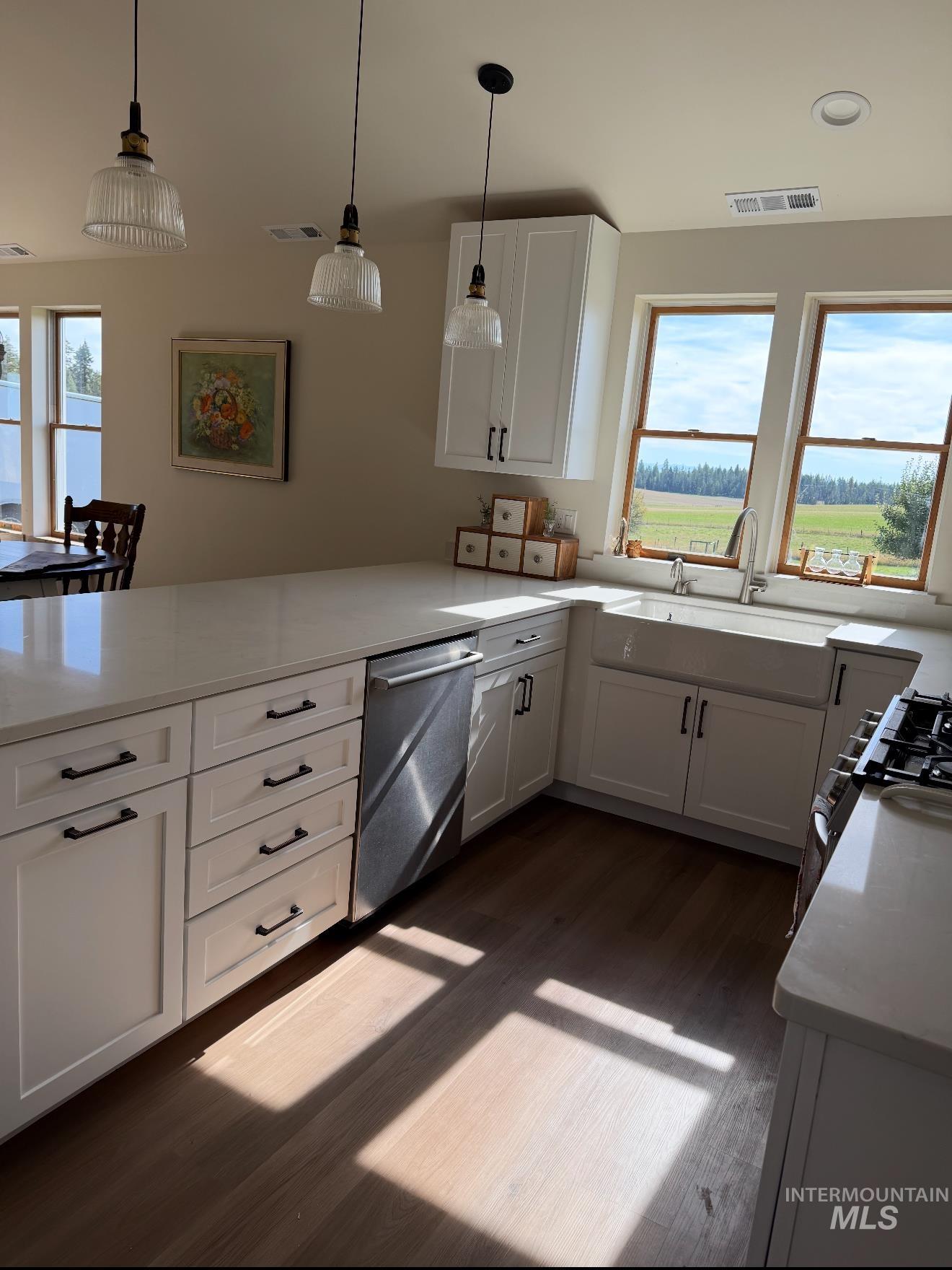 263 Glory Lane Orofino, ID 83544 - Photo 12 of 48 Kitchen with white cabinetry, dishwasher, hanging light fixtures, range with gas stovetop, and light stone counters