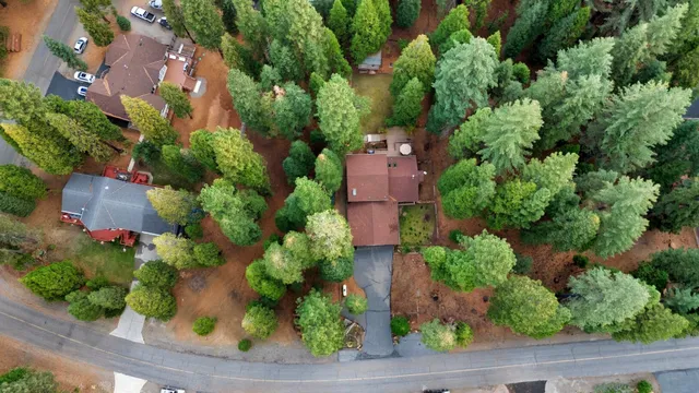 an aerial view of a house with a yard and garden