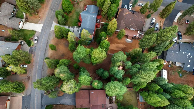 an aerial view of a house with a yard and garden