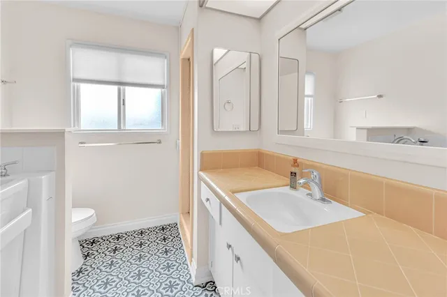 a bathroom with a sink a vanity and a mirror