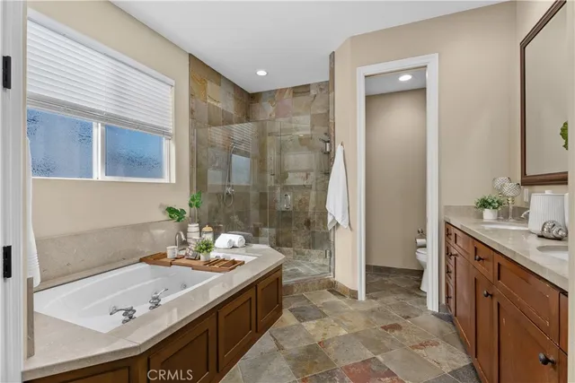 a bathroom with a tub sink and mirror