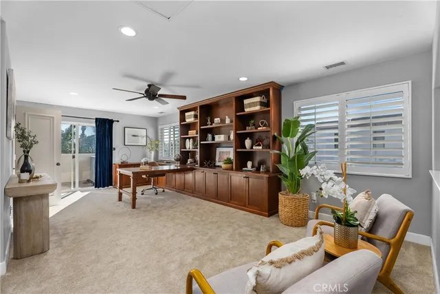 a living room with furniture and a potted plant