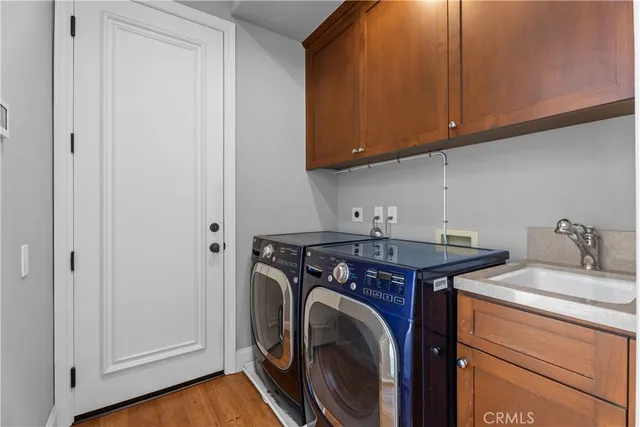 a utility room with sink dryer and washer