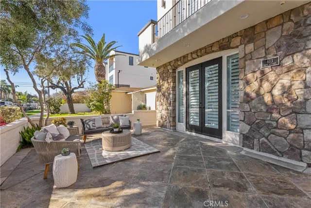 a view of a patio with couches and potted plants