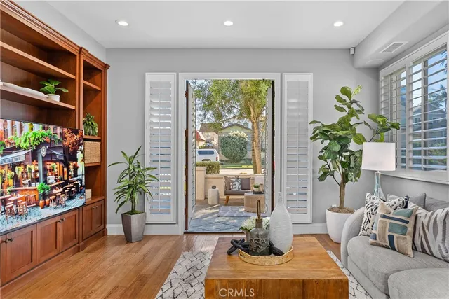 a living room with furniture fireplace and potted plant